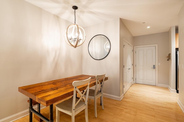 dining room featuring light wood-style floors, baseboards, a notable chandelier, and recessed lighting