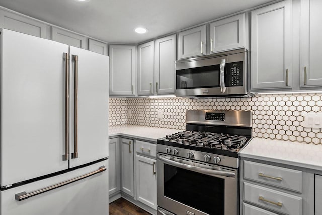 kitchen with stainless steel appliances, light countertops, and gray cabinetry