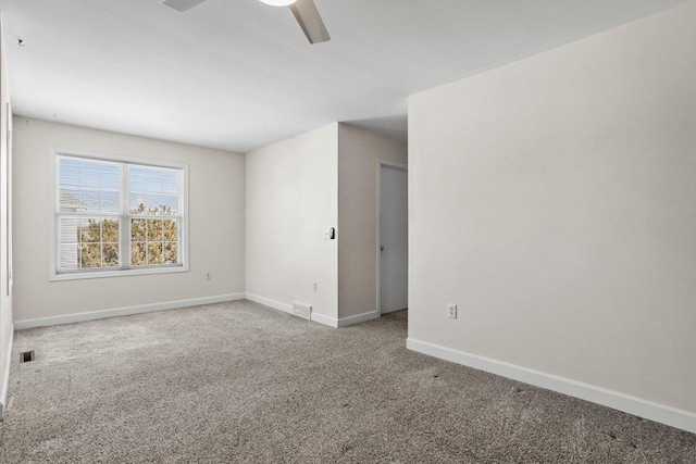 unfurnished room featuring a ceiling fan, carpet flooring, visible vents, and baseboards