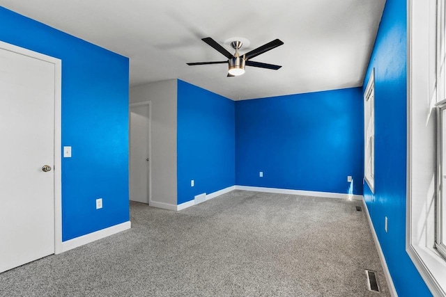 unfurnished bedroom with a ceiling fan, carpet, visible vents, and baseboards