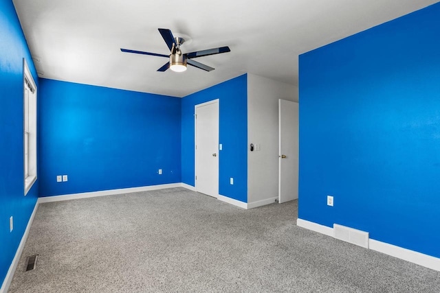 unfurnished bedroom with ceiling fan, carpet, visible vents, and baseboards