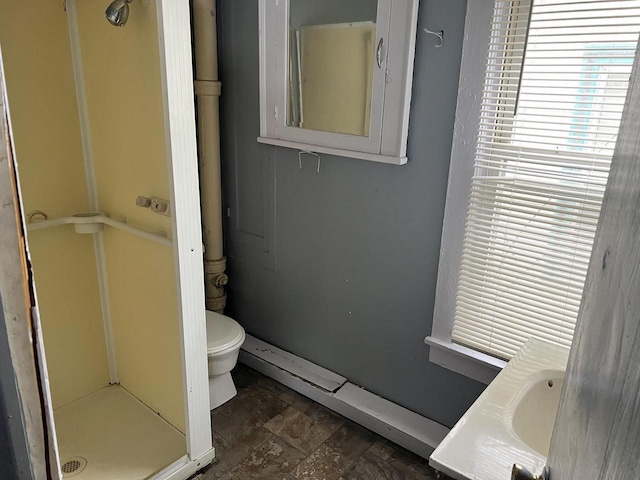 full bath featuring stone finish floor, a shower stall, toilet, and vanity