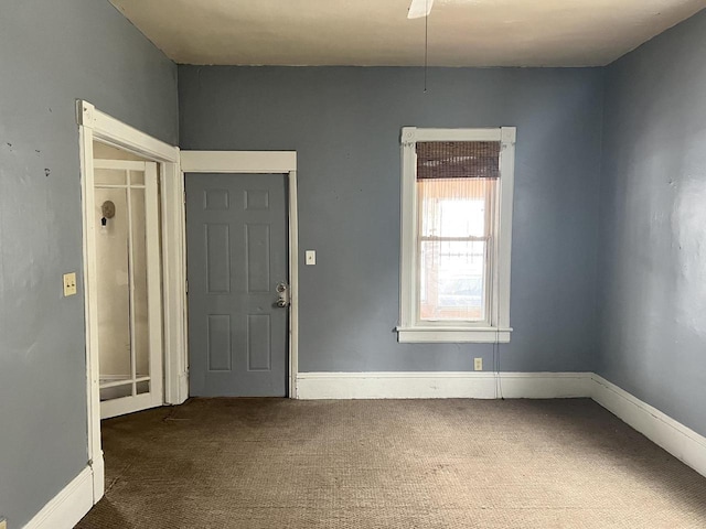 carpeted foyer entrance with baseboards