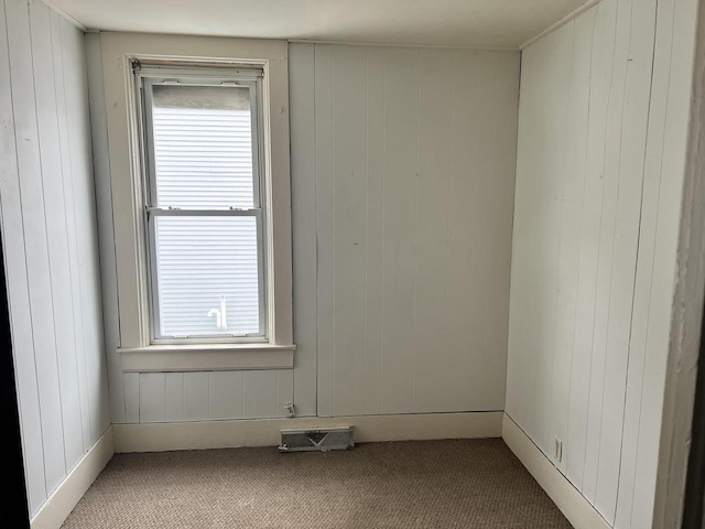 carpeted spare room featuring visible vents