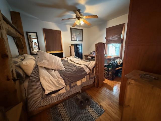 bedroom with a ceiling fan and wood finished floors