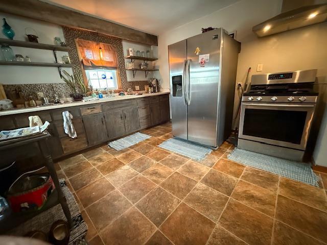 kitchen featuring stainless steel appliances, extractor fan, open shelves, and light countertops