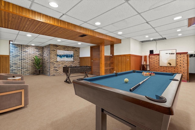 recreation room featuring a wainscoted wall, carpet, a drop ceiling, and recessed lighting