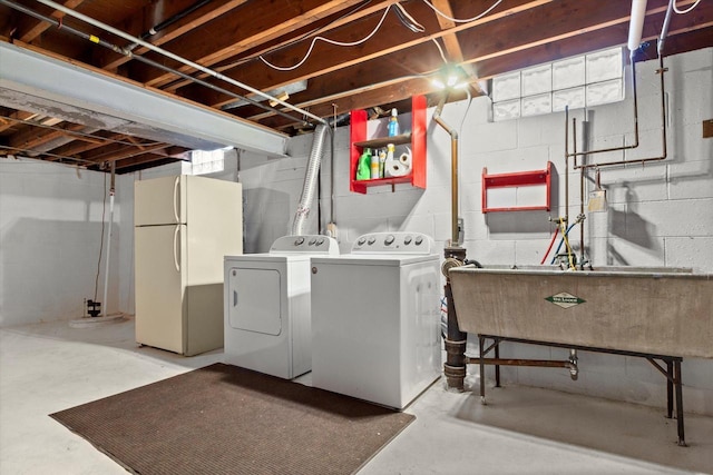 clothes washing area featuring laundry area, washer and clothes dryer, and a sink