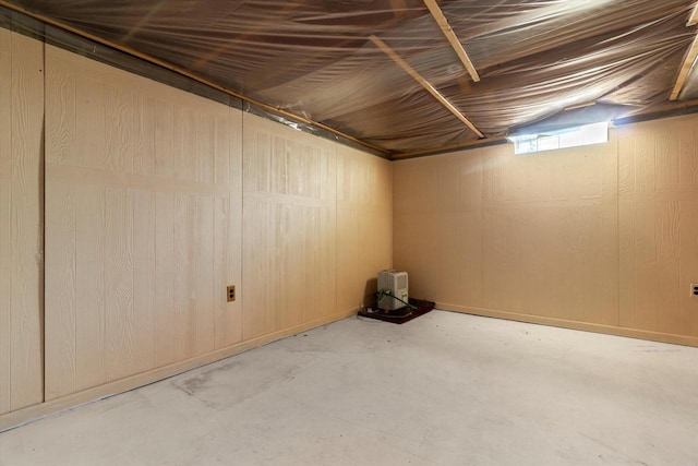 basement featuring wood walls