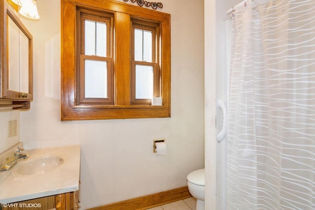 bathroom featuring curtained shower, tile patterned flooring, toilet, vanity, and baseboards