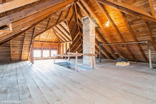 unfinished attic featuring an upstairs landing