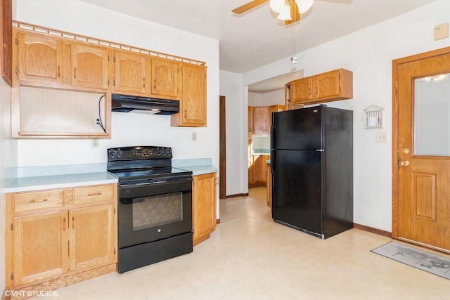 kitchen featuring black appliances, light floors, light countertops, and under cabinet range hood