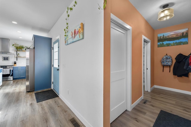 entryway featuring recessed lighting, light wood-type flooring, visible vents, and baseboards