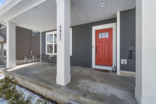 view of exterior entry featuring a porch