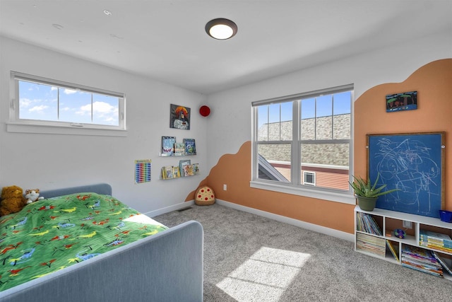 carpeted bedroom with multiple windows, visible vents, and baseboards