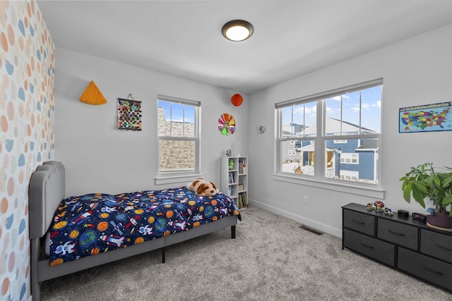 carpeted bedroom featuring visible vents and baseboards