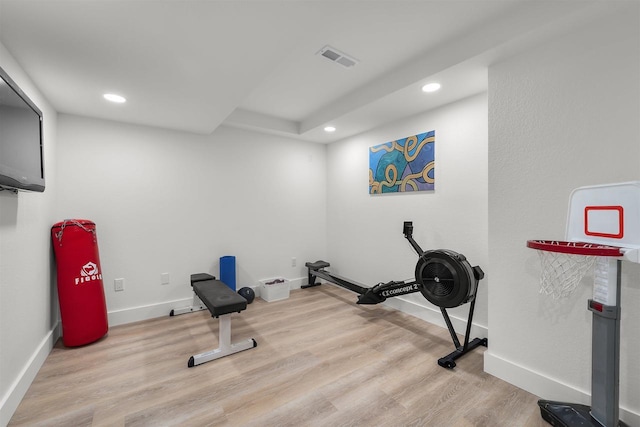 exercise area with recessed lighting, visible vents, baseboards, and wood finished floors