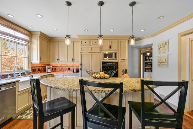 kitchen with decorative backsplash, built in appliances, cream cabinetry, and wood finished floors