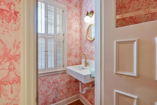 bathroom with baseboards and wallpapered walls