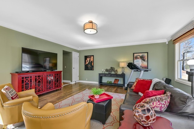 living room featuring crown molding, wood finished floors, and baseboards