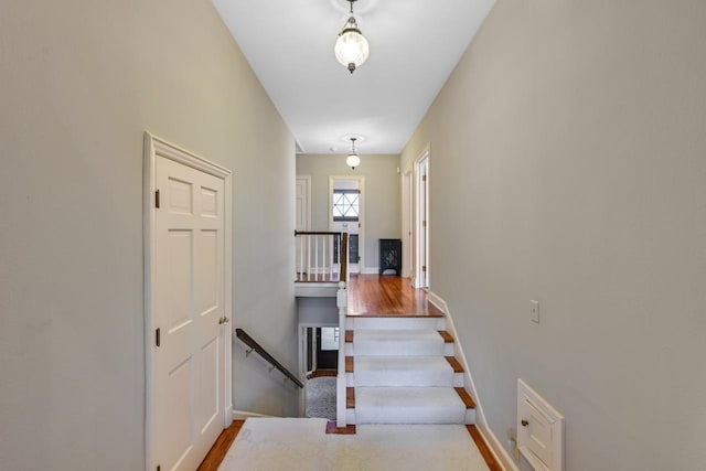 stairs featuring wood finished floors and baseboards