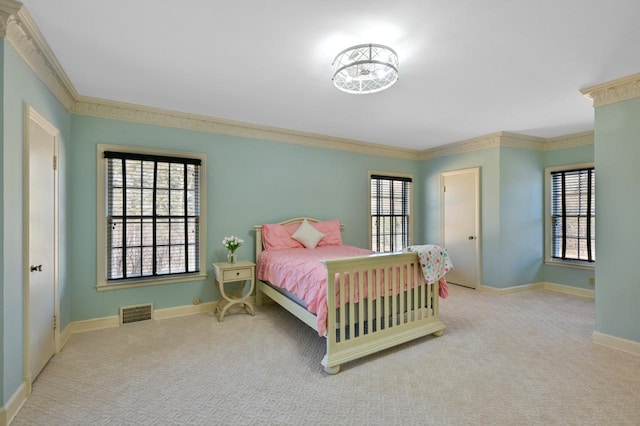 carpeted bedroom with multiple windows, baseboards, visible vents, and ornamental molding