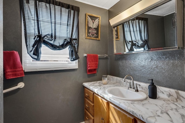 bathroom featuring vanity and a textured wall