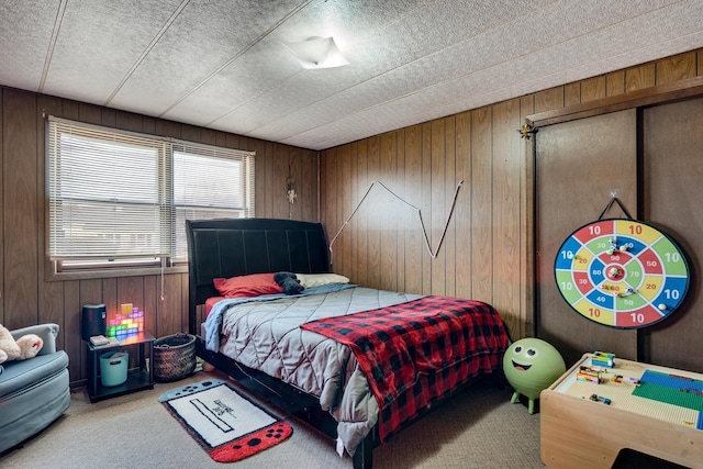 carpeted bedroom featuring wooden walls