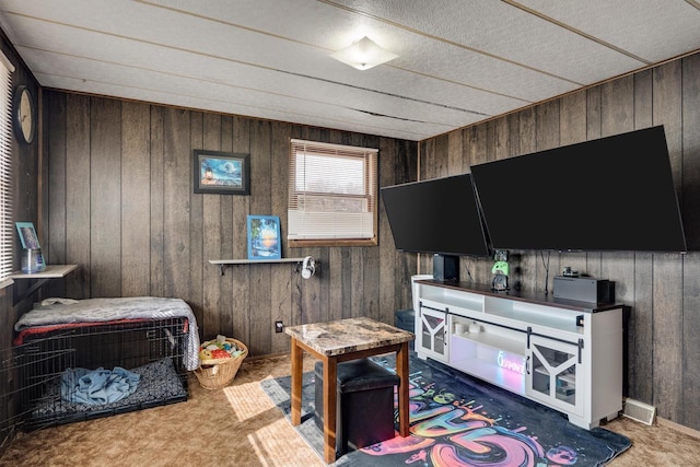 interior space featuring carpet floors, visible vents, and wooden walls