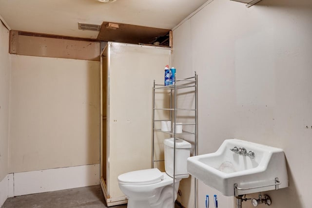 full bath with visible vents, toilet, a sink, concrete floors, and walk in shower