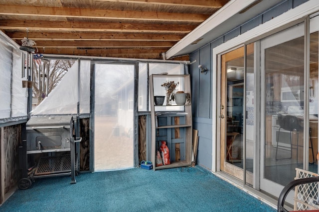 interior space with beamed ceiling and carpet flooring