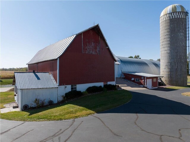2451 25th Ave, Rice Lake, WI 54868 - view of home's exterior featuring a barn, a yard, metal roof, and an outdoor structure