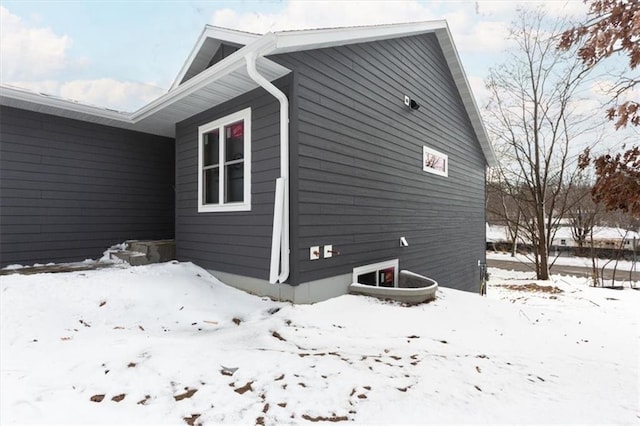 view of snowy exterior with a garage