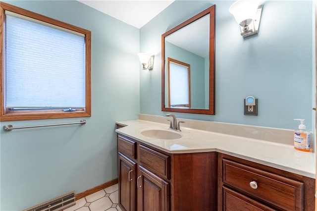 614 Westwood Dr, Chippewa Falls, WI 54729 - bathroom with tile patterned floors, baseboards, visible vents, and vanity