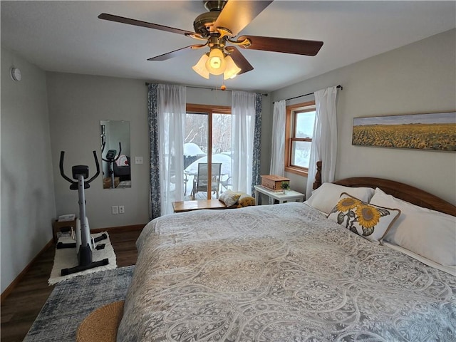 bedroom with dark wood-style floors, access to exterior, ceiling fan, and baseboards