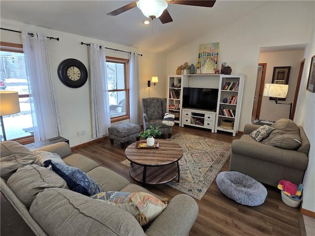 living room featuring a ceiling fan, lofted ceiling, baseboards, and wood finished floors