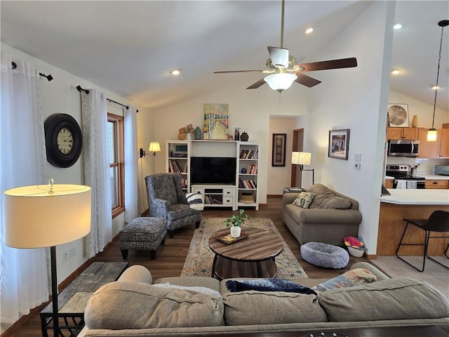 living area with a ceiling fan, lofted ceiling, and wood finished floors