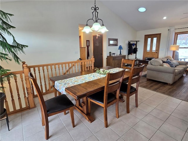 dining space featuring light tile patterned floors, high vaulted ceiling, and recessed lighting