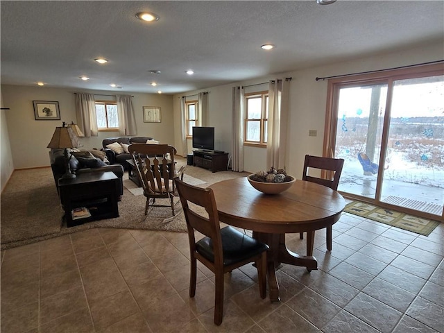 dining room featuring a textured ceiling, a wealth of natural light, and recessed lighting