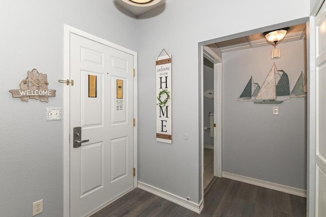 entryway with baseboards and dark wood-style flooring