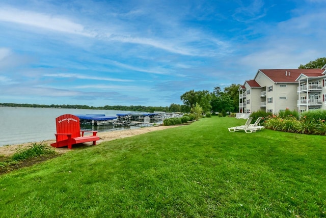 view of yard featuring a water view and a boat dock