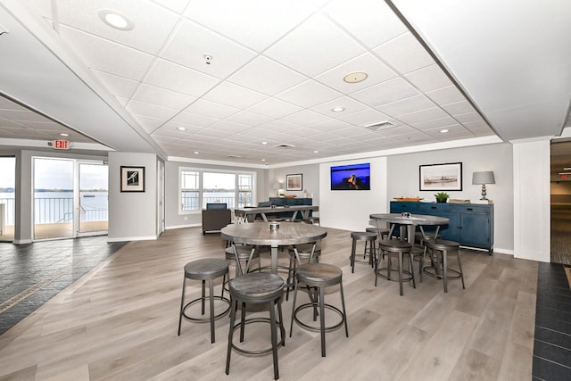 dining room with visible vents, baseboards, and wood finished floors