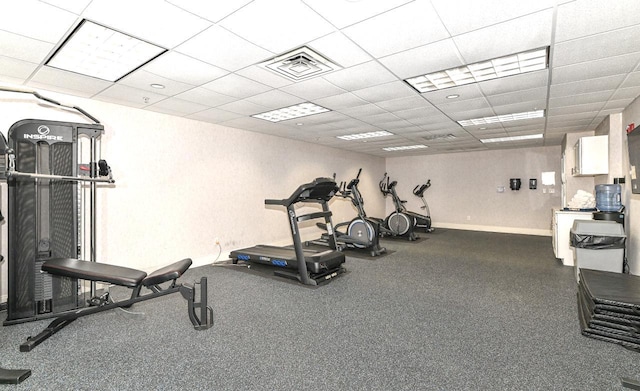 gym featuring a drop ceiling, visible vents, and baseboards