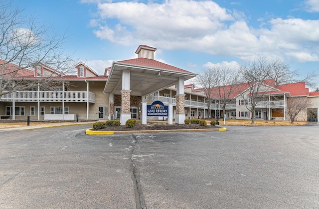 view of building exterior with uncovered parking