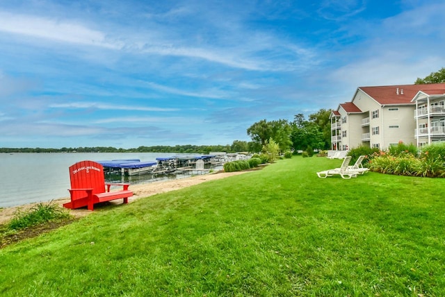 view of yard with a boat dock and a water view