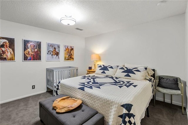 carpeted bedroom with a textured ceiling, visible vents, and baseboards