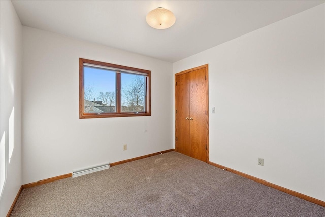 carpeted empty room with visible vents and baseboards