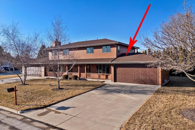 view of front of house featuring driveway, a porch, a chimney, and an attached garage