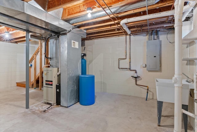 unfinished below grade area featuring heating unit, visible vents, electric panel, and stairway