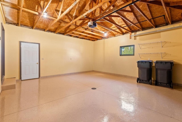 garage featuring baseboards and a garage door opener